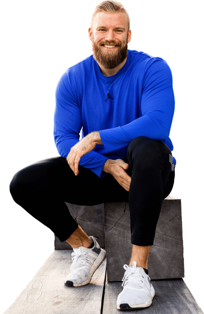 Bork fitness sitting on a wooden stairs. Wearing blue jumper and smiling